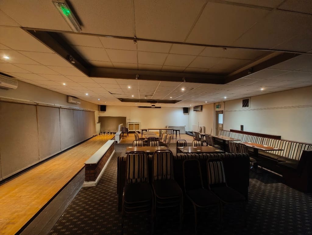 The skittle alley, a polished wooden lane running the length of the room with seating and tables alongside